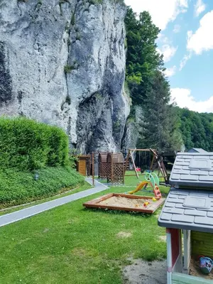 a playground in front of a rocky mountain at Zajazd Wernyhora in Sułoszowa