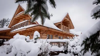 a log cabin in the snow at Jaśkowa Chata in Stryszawa