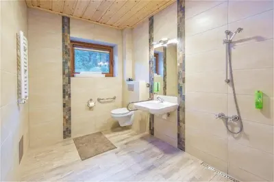 a bathroom with a sink and a toilet and a shower at Apartamenty 58 Czarny Groń in Rzyki