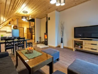 a living room with a large flat screen tv at Apartamenty 58 Czarny Groń in Rzyki
