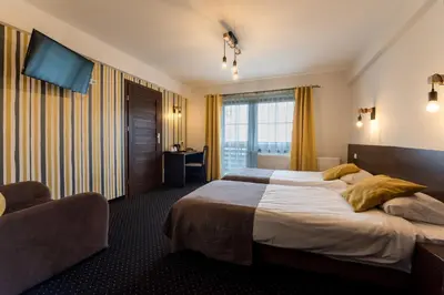 a hotel room with a large bed and a window at Hotel Beskidzki Raj Medical SPA in Stryszawa