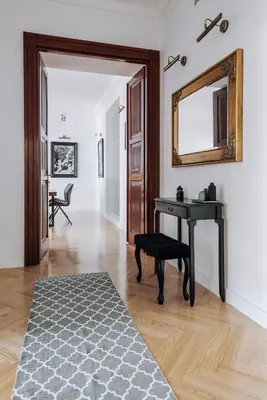 a living room with a table and a mirror at Szpitalna 20 Apartment 3 in Kraków