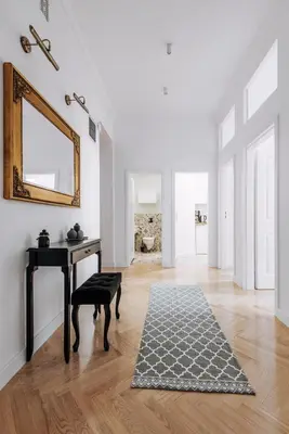 a living room with a table and a mirror at Szpitalna 20 Apartment 3 in Kraków