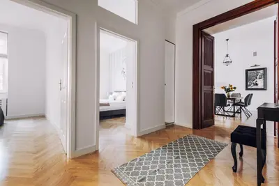 a living room with white walls and a wooden floor at Szpitalna 20 Apartment 3 in Kraków