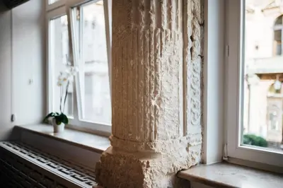 a pillar in a room with two windows at Szpitalna 20 Apartment 3 in Kraków
