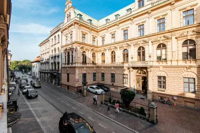a large building with cars parked in front of it at Szpitalna 20 Apartment 3 in Kraków