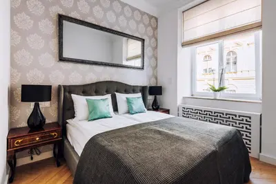 a bedroom with a bed and a mirror on the wall at Szpitalna 20 Apartment 3 in Kraków