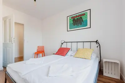 a bedroom with a bed with two pillows on it at City Center Apartment by CityBeat in Kraków