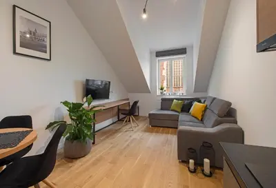 a living room with a couch and a table at Aparthotel BC 29 Residence in Kraków