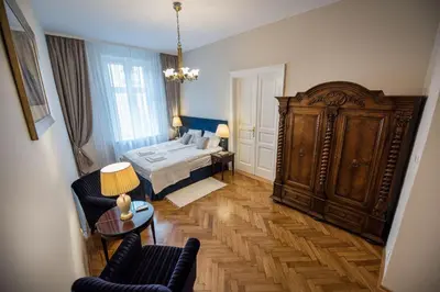 a bedroom with a bed and a large wooden cabinet at MJZ Apartments Old Town Krakow in Kraków