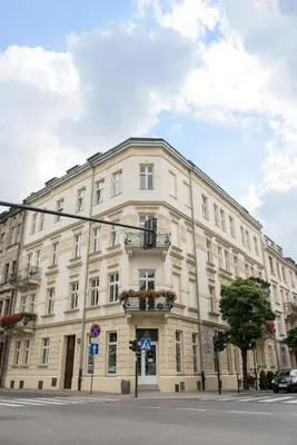 a large white building on the corner of a street at MJZ Apartments Old Town Krakow in Kraków