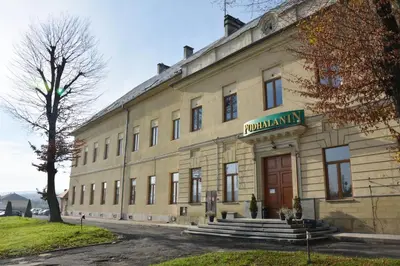 a room with three beds with blue sheets and a window at Podhalanin noclegi in Wadowice