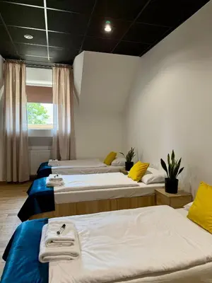 a room with two beds and a window at Podhalanin noclegi in Wadowice