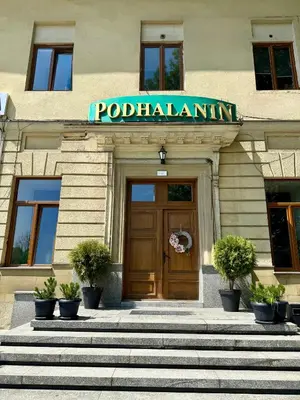 a building with a door and a sign on it at Podhalanin noclegi in Wadowice