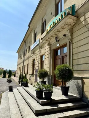 a building with a sign on the front of it at Podhalanin noclegi in Wadowice