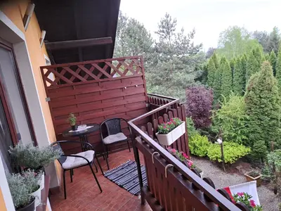 a balcony of a house with a table and chairs at Willa Krakowia in Krzeszowice