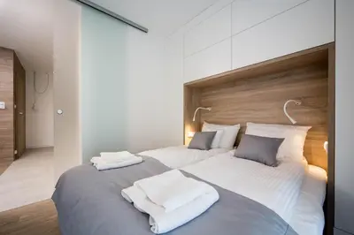 a large bed with two white towels on it at LEMIR Apartments Wawrzyńca 21 in Kraków