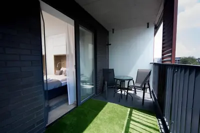 a balcony with a bed and a table and chairs at LEMIR Apartments Wawrzyńca 21 in Kraków