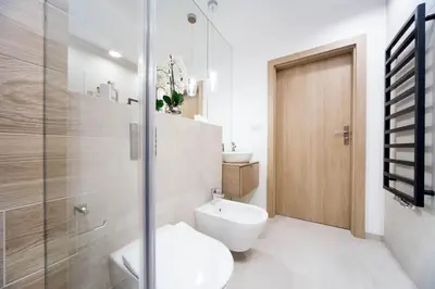 a bathroom with a toilet and a glass shower at LEMIR Apartments Wawrzyńca 21 in Kraków