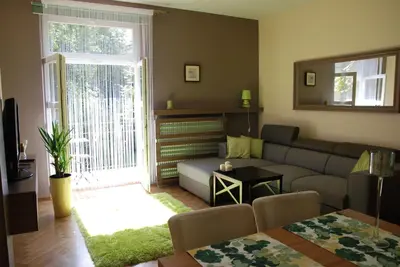 a living room with a couch and a table at Excellent apartment with balcony in Kraków