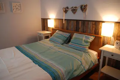 a bedroom with a large bed with a wooden headboard at Excellent apartment with balcony in Kraków