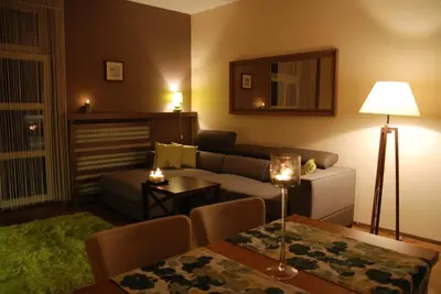 a living room with a couch and a table at Excellent apartment with balcony in Kraków