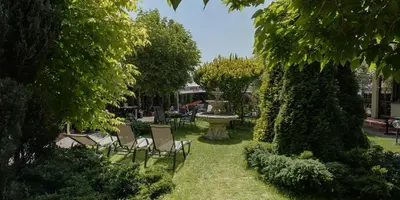 a park with chairs and a fountain in the grass at Eko Hotel Na Wierzynka & Park Pinokia in Wieliczka