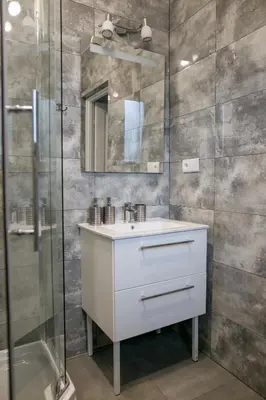 a bathroom with a white sink and a shower at Eko Hotel Na Wierzynka & Park Pinokia in Wieliczka