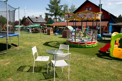 a carnival park with a table and chairs and a playground at Eko Hotel Na Wierzynka & Park Pinokia in Wieliczka
