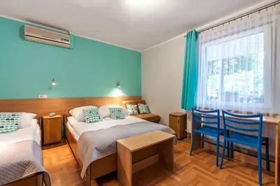 a hotel room with two beds and a window at Eko Hotel Na Wierzynka & Park Pinokia in Wieliczka