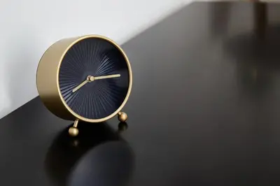 a gold and blue clock sitting on a table at St Agnes Apartments Attic in Kraków