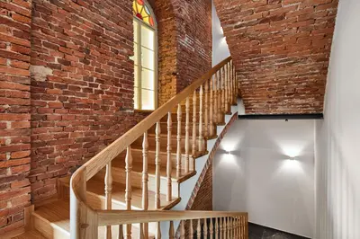 a brick staircase with a window and a brick wall at St Agnes Apartments Attic in Kraków