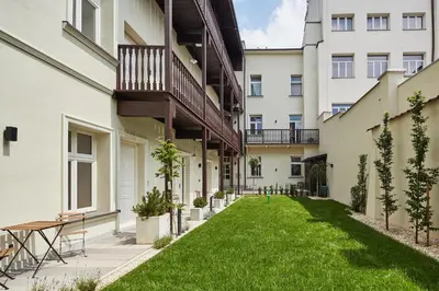 a courtyard of an apartment building with a green lawn at St Agnes Apartments Attic in Kraków