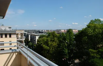 a view of a city from the balcony of a building at Apartment AMUR in Kraków