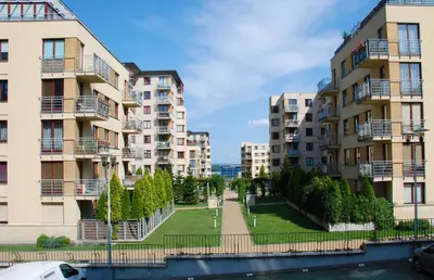 a row of apartment buildings next to a river at Apartment AMUR in Kraków