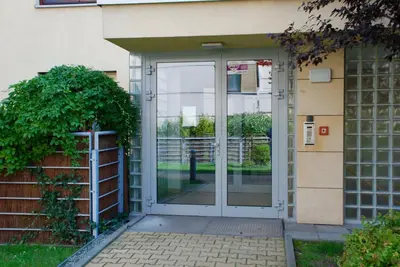 an entrance to a building with a glass door at Apartment AMUR in Kraków