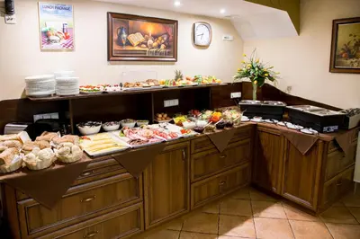 a buffet line with many different types of food at Hotel Maksymilian in Kraków