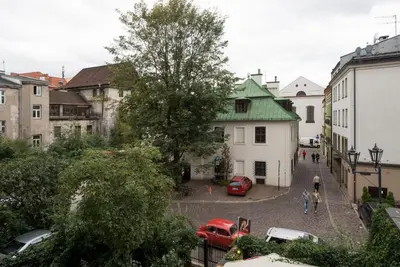 a city street with cars parked in a parking lot at Sunflower Apartment in Kraków