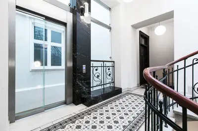 a staircase in a house with a glass door at Old Town Brigue Apartment by Otium in Kraków