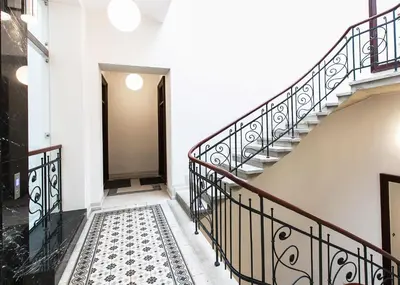 a staircase in a building with a stair case at Old Town Brigue Apartment by Otium in Kraków