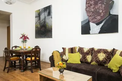 a living room with a couch and a table at Old Town Brigue Apartment by Otium in Kraków
