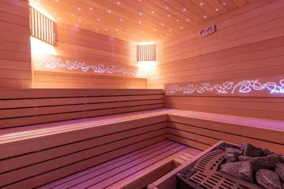 a sauna with a bench and lights in it at Margerita in Modlnica