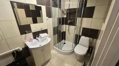 a bathroom with a sink and a toilet and a shower at Krakow For You Budget Apartments in Kraków