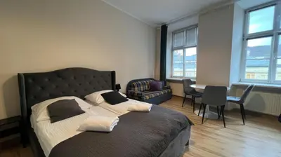 a bedroom with a bed and a table and chairs at Krakow For You Budget Apartments in Kraków
