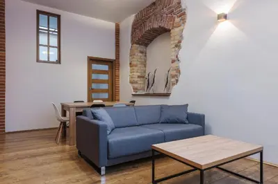 two beds in a room with a picture of a castle at Krakow For You Budget Apartments in Kraków