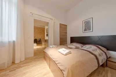 a bedroom with a bed with towels on it at Krakow For You Budget Apartments in Kraków