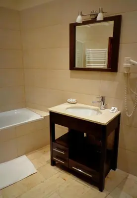 a white bathroom with a sink and a shower at Krakow For You Budget Apartments in Kraków