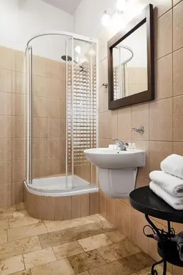 a bathroom with a sink and a tub and a mirror at Krakow For You Budget Apartments in Kraków