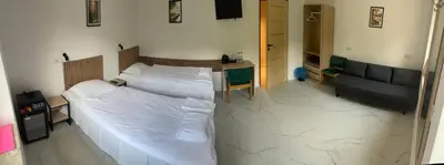 a bedroom with two beds and a desk in it at Hotel Górsko in Wieliczka