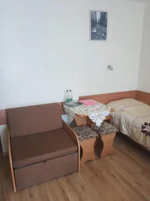 a room with a bed and a table and a chair at Hotel Górsko in Wieliczka